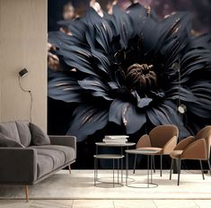 a living room filled with furniture and a large black flower wall mural on the wall