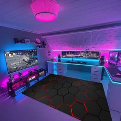 a gaming room with neon lights and video game equipment