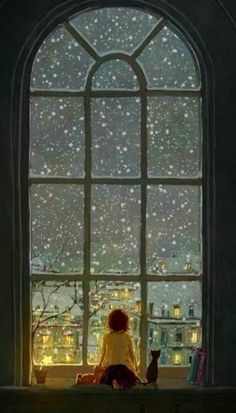 a woman sitting on a window sill looking out at the city lights and rain