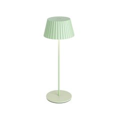 a white lamp with a green shade on it