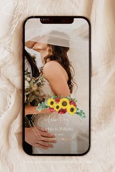 an iphone case with a wedding photo and sunflowers on the front, sitting on a white blanket