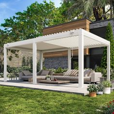 an outdoor living area with couches and tables in the grass, surrounded by greenery