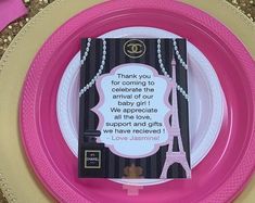 a pink and gold plate with a card on it