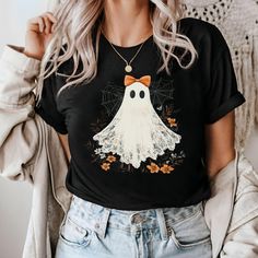 Halloween Ghost Sweatshirt, Ghost Pumpkin T-Shirt, Coquette Bow Girl Halloween T-Shirt, Halloween Fall Shirt, Halloween Flower Ghost Shirt HOW TO ORDER 1️) Please review all the information provided below before placing an order. 2️) Select the shirt type and size. 3️) Select the color of the shirt using the following options. 4) Select your design (Personalization Box) if applicable. 5) Need more items? Add your current item to your cart and if you like to add more items to your order please cl Cute Halloween Short Sleeve Tops, Cute Short Sleeve Halloween Tops, Cute Short Sleeve Tops For Halloween, Cute Halloween Graphic Print T-shirt, Cute Orange Halloween T-shirt, Cute Halloween Cartoon Print T-shirt, Cute Halloween T-shirt With Short Sleeves, Flower Ghost, Shirt Coquette