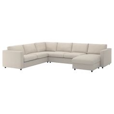 a white sectional couch sitting on top of a white floor