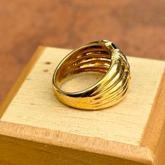 a gold ring sitting on top of a wooden box