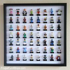 lego minifigures are displayed in a shadow box on the wall above a shelf