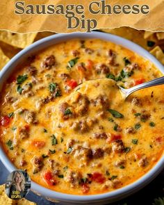 a bowl of sausage cheese dip with tortilla chips