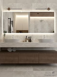 a bathroom with two sinks and a large mirror over it's counter top,