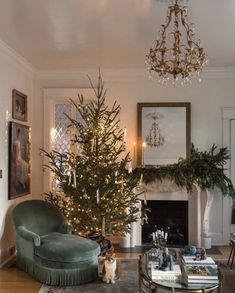 a living room filled with furniture and a christmas tree in the middle of the room