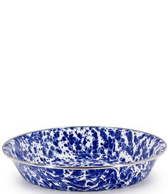 a blue and white bowl sitting on top of a table next to an empty plate