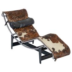 a chaise lounge chair with cow hide cushions