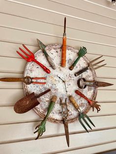 a clock made out of old garden tools