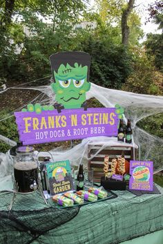 a table topped with halloween treats and drinks