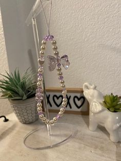 Aesthetic beautiful purple cell phone charm. This charm has a large black tinted bow tie, black tinted bear, hearts, purple beads and faux pearls. Phone Charms Aesthetic Purple, Purple Phone Charm, Cell Phone Charms, Purple Beads, Phone Plug, Phone Lanyard, Large Bow, One Piece Luffy, Phone Charm