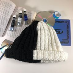 an open book, cd and knitted hat on a table