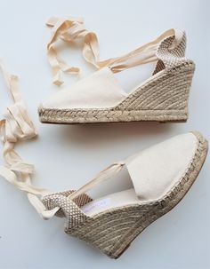 "Lace-up espadrille wedges in IVORY canvas, 9cm heels (3.54 inches). Laces in the same ivory canvas, can be tied up close to the knees, or wrapped around the ankles. The ribbon ends come glued to prevent fraying. The canvas is hand-sewn with visible seam, following traditional techniques. Reinforced in the front with extra stitching. Padded insole. The rope soles are anti-slippery, made of threaded jute fiber and covered with rubber. The fiber braids have been handwoven by Spanish artisans accor Lace Up Espadrille Wedges, Heel Wedges, Ribbon Ends, Lace Up Espadrilles, High Heel Wedges, La Pointe, Vegan Shoes, Espadrille Shoes, Wedge Espadrille