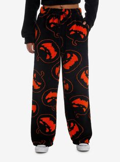 Keep it cozy this fall with some scary cute pajama pants! These fuzzy PJ pants feature sinister jack-o'-lanterns all over. Comes with an elasticated drawstring waistband and pockets. Pair with the matching fuzzy hoodie for the full lounge look.100% polyesterWash cold; dry lowImportedListed in junior sizesModel is 5'9"Model wears size Medium Halloween Pjs Women Aesthetic, Halloween Jammies, Scream Pjs, Fuzzy Halloween Pajama Pants, Halloween Sweatpants, Cute Fall Pants, Halloween Pj Pants, Matching Halloween Pajamas, Alt Pajamas