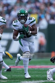 a football player running with the ball during a game