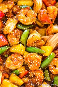 stir fried shrimp and vegetables with sesame seeds in a wok, ready to be eaten