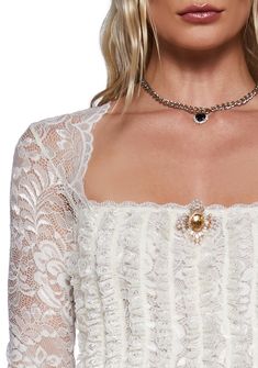 This long sleeve top has a sheer floral lace construction, a front vertical ruffled design, a scalloped lace neckline, and a front removable gemstone brooch with a pin closure. Gemstone Brooch, Sugar Thrillz, Lace Neckline, Fairy Dress, Lace Ruffle, Scalloped Lace, Kawaii Fashion, Dolls Kill, Exclusive Collection