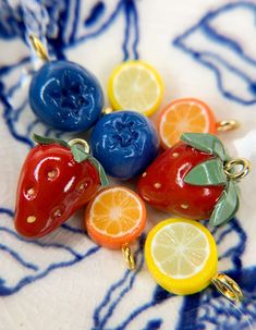 several fruits and vegetables are sitting on a blue and white plate with gold trimmings