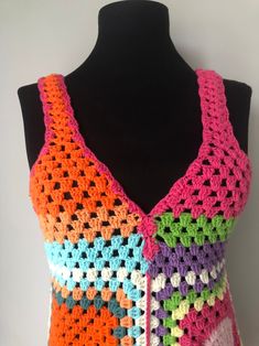 a crocheted vest is shown on a mannequin