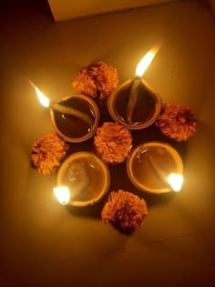 candles with pom poms are arranged in the shape of a circle on a table