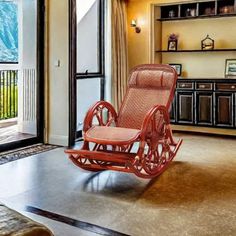 a rocking chair in the middle of a living room with sliding glass doors leading outside