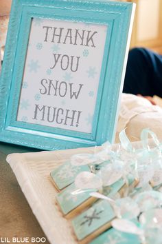 there is a sign that says thank you snow much next to some cookies and candies