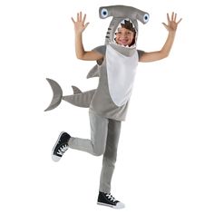 a young boy dressed in a shark costume