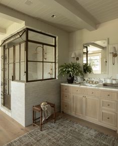 a large bathroom with two sinks and mirrors