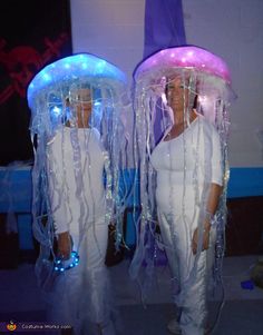 two women dressed in costumes made out of plastic wrap and led lights, standing next to each other with the caption diy costumes for women