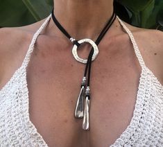 Crafted with meticulous care and a touch of bohemian charm, this handmade leather lariat necklace is the epitome of elegance. Perfect for beach weddings or adding a hint of sophistication to everyday wear, this pendant necklace exudes a unique sense of style. The Y-shaped design adds a modern twist to the classic lariat, making it a versatile piece that can effortlessly transition from day to night. The supple leather cord of this boho necklace enhances its natural appeal, while the pendant provides a focal point that captures attention. Whether you're looking to elevate a casual outfit or complement a formal dress, this leather necklace is sure to make a statement.  Embrace your inner free spirit with this bohemian-inspired accessory that embodies both simplicity and sophistication. Each Bohemian Silver Necklace With Sliding Knot, Adjustable Silver Artisan Lariat Necklace, Festival Lariat Choker Necklace With Adjustable Length, Festival Adjustable Lariat Choker Necklace, Handmade Lariat Festival Necklace, Artisan Lariat Necklace For Festivals, Handmade Festival Lariat Necklace, Adjustable Bohemian Lariat Necklace Nickel Free, Artisan Adjustable Lariat Necklace