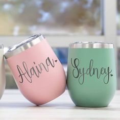 three wine tumblers sitting on top of a table next to each other with names painted on them