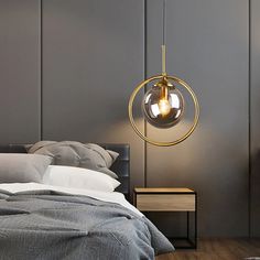 a bedroom with a bed, night stand and lamp hanging from the ceiling above it