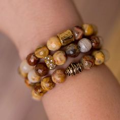 Add a touch of nature to any outfit with this unique stack of beaded bracelet designed and handmade in the South featuring semi-precious gemstones and gold accents. Each stack is carefully put together with perfect color combinations to accent the stones best features. Pair it with jeans and your favorite top for all day style. One size fits most. Stretches slightly for a comfortable fit. Handmade in Jacksonville, Florida Each of our designs are hand crafted and may vary slightly. Earthy Beaded Bracelets With Natural Jasper Stones, Earthy Jasper Beaded Bracelets With Natural Stones, Earthy Jasper Beaded Bracelet With Natural Stones, Gold Earthy Beaded Bracelets With Round Beads, Gold Agate Bracelet With Gemstone Beads, Gold Beaded Bracelets With Natural Stones, Earthy Beaded Bracelets With Natural Agate Stones, Earthy Agate Beaded Bracelets With Natural Stones, Gold Rondelle Beaded Bracelets With Natural Stones