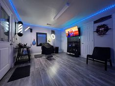 a living room filled with furniture and a flat screen tv mounted to the side of a wall