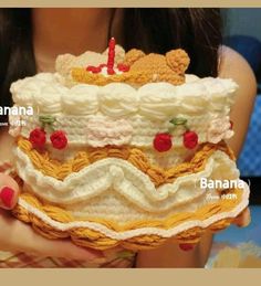 a woman holding a cake with teddy bears on it's top and bottom tier