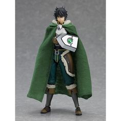 an action figure wearing a green cape and holding a white object in one hand, while standing on a gray surface