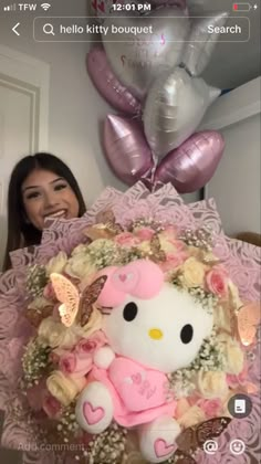 a woman holding a hello kitty bouquet in front of her face and balloons behind her