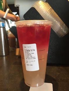 a red drink sitting on top of a table