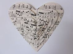 three heart shaped wooden pieces with musical notes on them