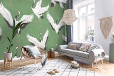 a living room with green walls and white birds on the wall