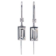 Modern drop earrings with two diamonds baguette cut weighing each over 2 carats, which is quite rare and difficult to find. They weigh 4.08 carats in total and have been graded IJ VVS ( white face-up) by our in-house GIA Graduated Gemologist. The make is excellent with the attention to detail and proportions typical of "Haute Joaillerie" standards. They bear the french "eagle's head" hallmark state stamp for 18 karat gold. Platinum Earrings With Baguette Cut Diamonds, Formal Earrings With Baguette Cut Single Diamonds, Formal Earrings With Baguette Cut Diamonds, Platinum Diamond Cut Baguette Earrings, Platinum Baguette-cut Diamond Earrings, Platinum Baguette Cut Diamond Earrings, Classic Platinum Baguette Cut Earrings, Classic Baguette Cut Platinum Earrings, Modern White Gold Emerald Cut Earrings