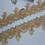 the gold lace is being sewn together