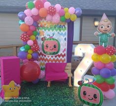 an outdoor birthday party with balloons, decorations and decor for the number two in front of it