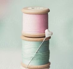 three spools of thread are stacked on top of each other by jodi lenski for stocksy