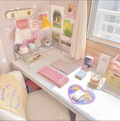 a white desk topped with a laptop computer next to a window