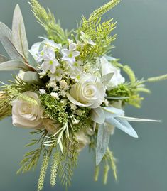 Beautiful Wedding Bouquet, made with quality artificial flowers and foliage including roses, gypsophila, baby's breath, silver grey foliage etc.  Measures approx 34cms across. I only use the best flowers and every bouquet is unique and bespoke.   I have 100% positive customer satisfaction so please drop me a message if I can help with your wedding flowers, all colours and styles.  Matching items available, including bridesmaids bouquets, buttonholes, corsages, flowergirl wands etc. Handle can be finished with ivory, white or sage satin ribbon with pearl pins. Please check out my other listings. Thank you Bridal Flowers Sage Green, White And Sage Green Bouquet, Sage Green And White Flower Bouquet, White And Green Foliage Bouquet, Sage Green + White Flowers Bouquet Real, Sage Green Wedding, Baby S Breath, Green Wedding, Bridesmaid Bouquet